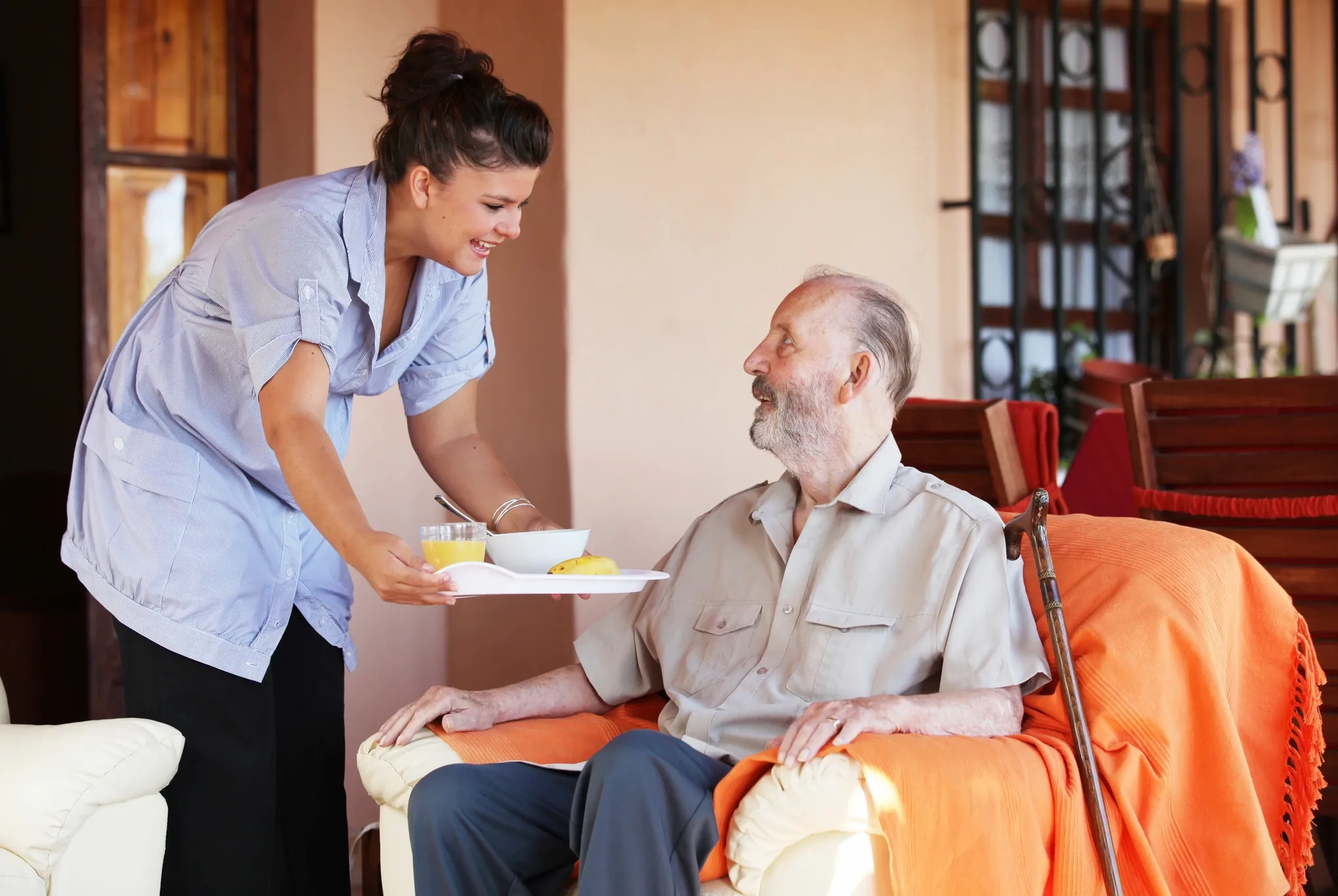 Caregiver helping elderly man
